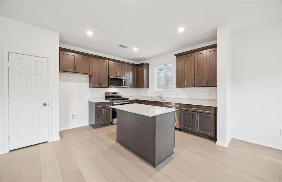 Spacious kitchen with eat-in bartop island