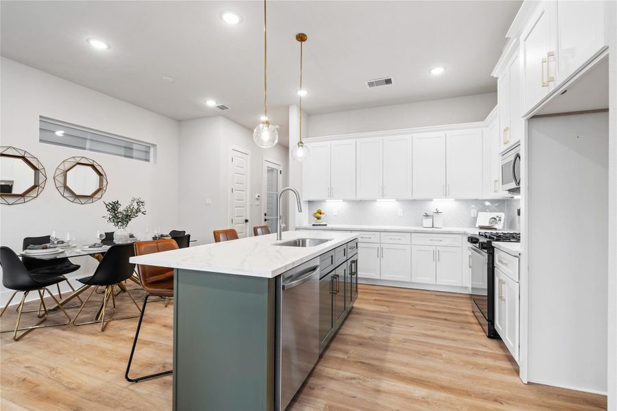 Whether it’s casual mornings or hosting friends, the oversized island creates a natural place to gather, blending function with a space that feels warm and inviting.