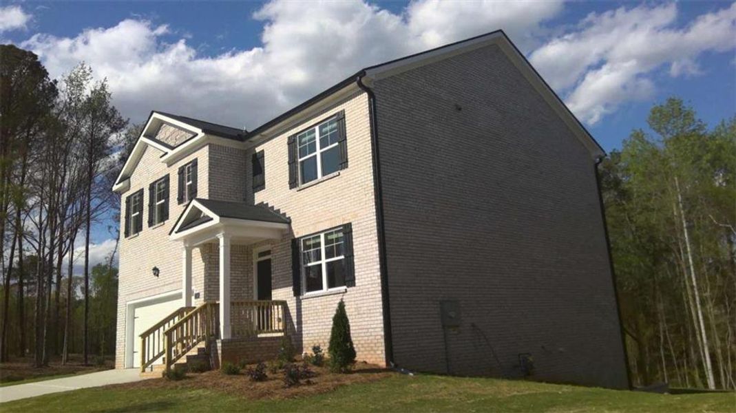 Front exterior of a new home in The Reserve at Calcutta, Stockbridge, GA, highlighting curb appeal (Image 30).