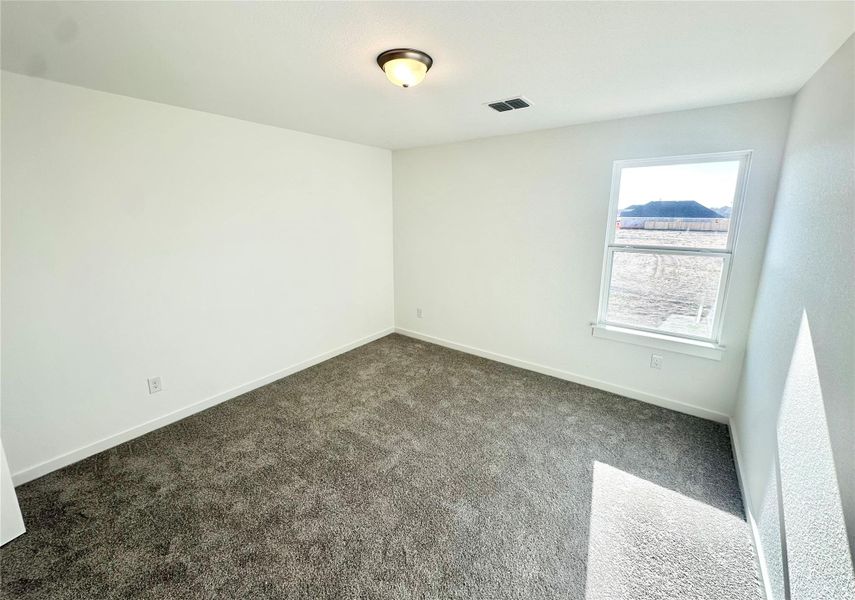 Spare room with carpet and baseboards