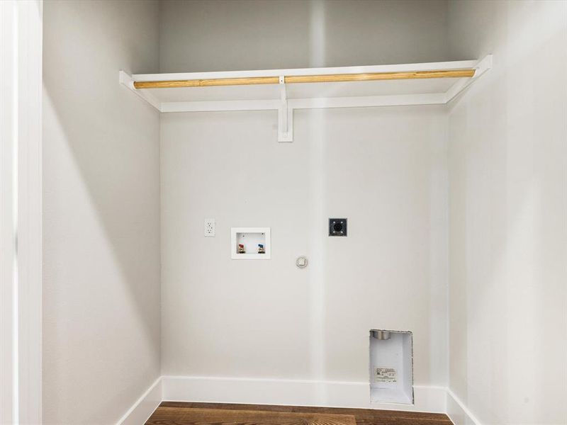 Washroom with dark wood-type flooring, hookup for a washing machine, hookup for an electric dryer, and gas dryer hookup Washroom with dark wood-type flooring, hookup for a washing machine, hookup for an electric dryer, and gas dryer hookup