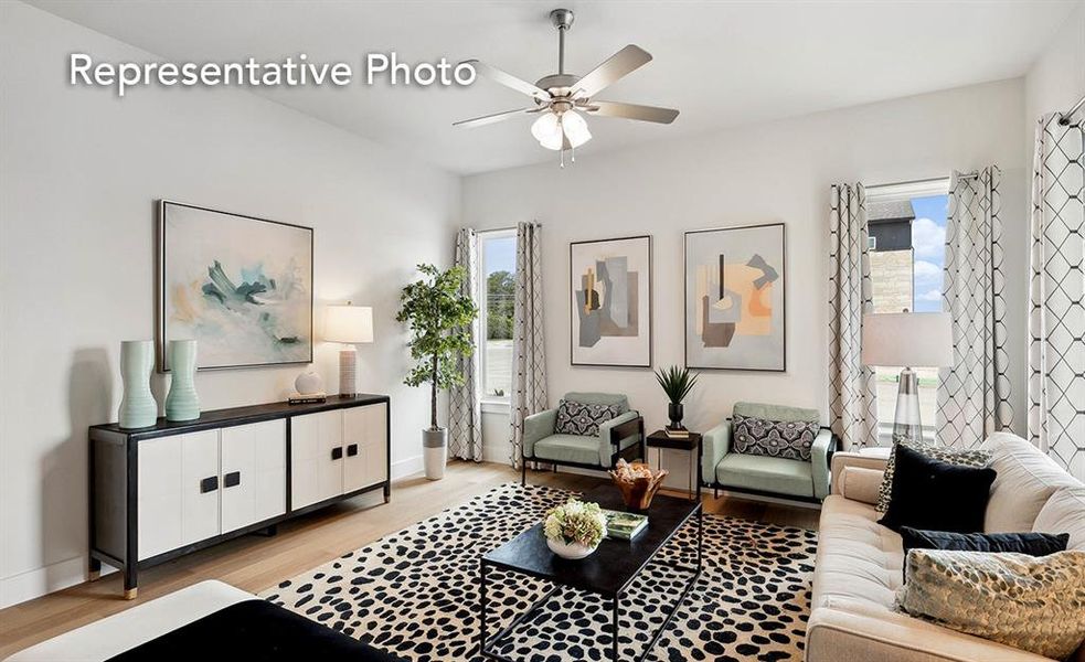 Living room with ceiling fan and light wood-type flooring