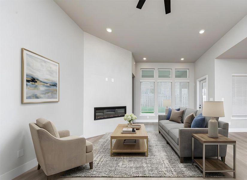 The open and airy Family Room is designed for seamless entertaining and showcasing striking architectural details with large tall windows, high ceilings with ceiling fan, recessed lighting, a beautiful electric fireplace, and durable flooring. *Virtually Staged The open and airy Family Room is designed for seamless entertaining and showcasing striking architectural details with large tall windows, high ceilings with ceiling fan, recessed lighting, a beautiful electric fireplace, and durable flooring. *Virtually Staged