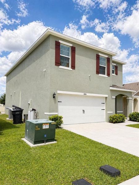 Front exterior of a new home in , Kissimmee, FL, highlighting curb appeal (Image 25).