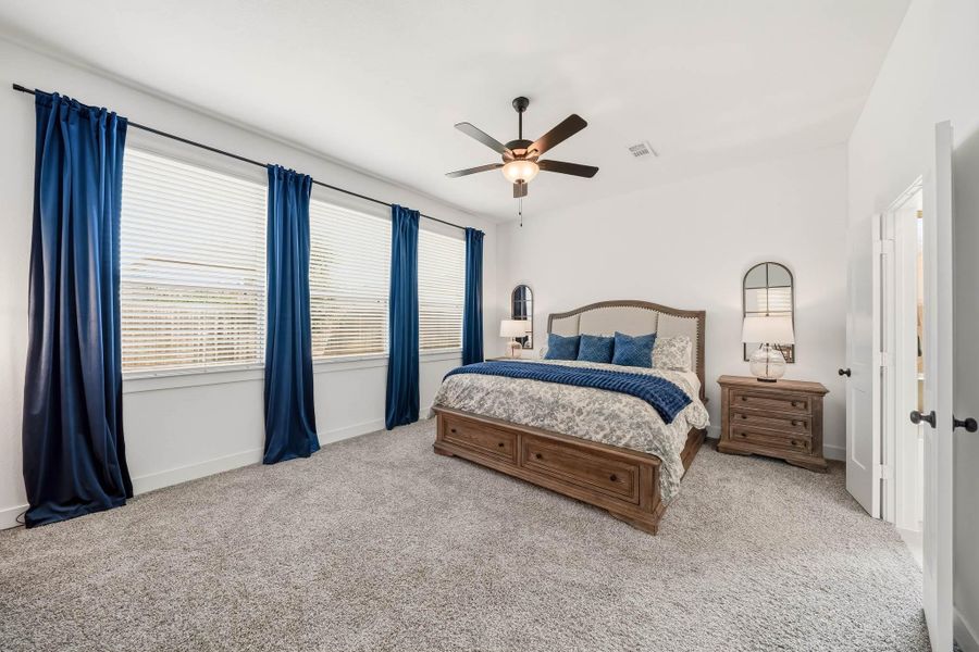 The luxurious primary retreat offers a serene escape, where plush carpeting creates a soft, inviting foundation and enhances the room’s sense of warmth and comfort. Its refined ambiance provides an elegant setting to unwind, with a polished, private feel that elevates everyday living.