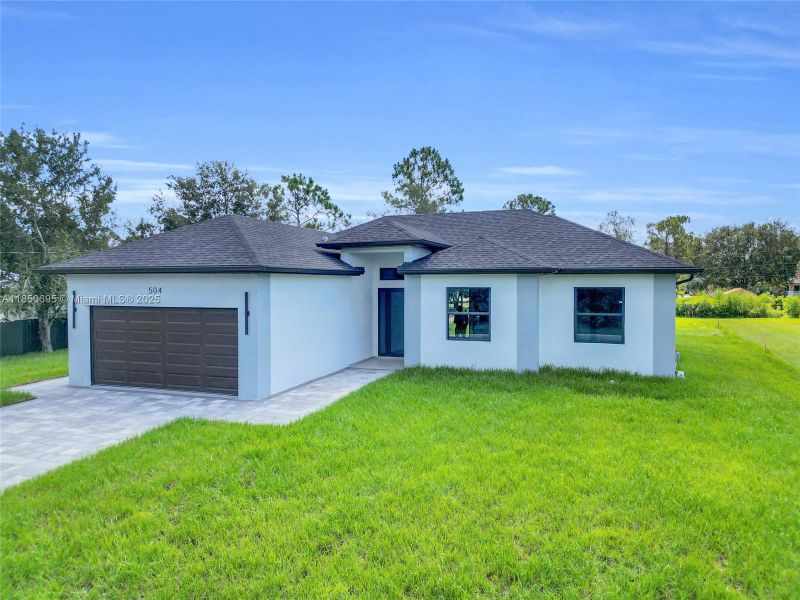 Front exterior of a new home in , Lehigh Acres, FL, highlighting curb appeal (Image 2). Front exterior of a new home in , Lehigh Acres, FL, highlighting curb appeal (Image 2).