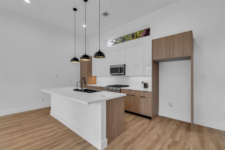 The kitchen is equipped with stainless steel appliances and includes a designated space for a refrigerator, ready for move-in and everyday use. The kitchen is equipped with stainless steel appliances and includes a designated space for a refrigerator, ready for move-in and everyday use.