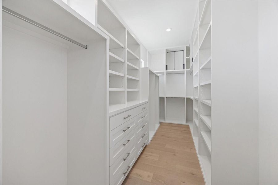 One of the two walk-in closets with custom built-ins.
