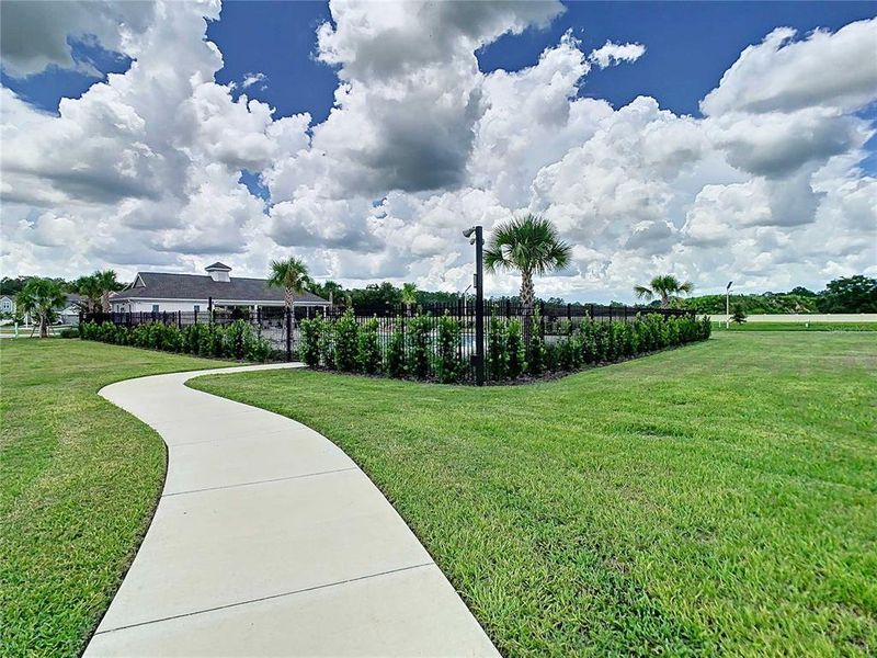 Front exterior of a new home in Pasadena Point, Wesley Chapel, FL, highlighting curb appeal (Image 23). Front exterior of a new home in Pasadena Point, Wesley Chapel, FL, highlighting curb appeal (Image 23).