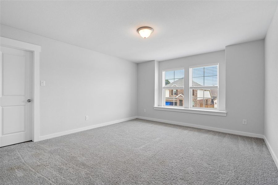 Carpeted empty room featuring baseboards Carpeted empty room featuring baseboards