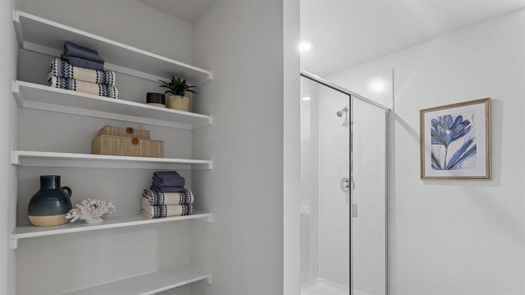 Full bath featuring a shower stall and a closet Full bath featuring a shower stall and a closet