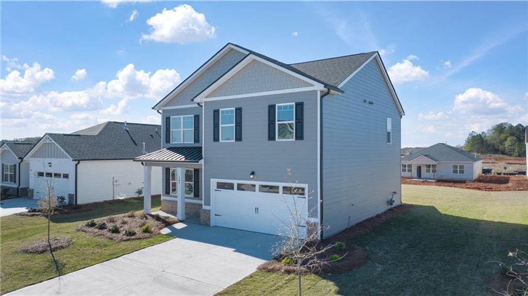 Front exterior of a new home in Twin Lakes, Hoschton, GA, highlighting curb appeal (Image 17).