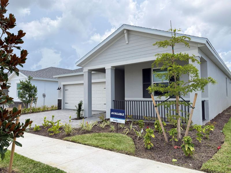 Front exterior of a new home in Crescent Lakes - Reserve Series, Punta Gorda, FL, highlighting curb appeal (Image 10). Front exterior of a new home in Crescent Lakes - Reserve Series, Punta Gorda, FL, highlighting curb appeal (Image 10).
