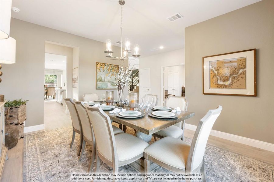 Formal dining room with rectangular table, eight upholstered chairs, chandelier, and hardwood floors