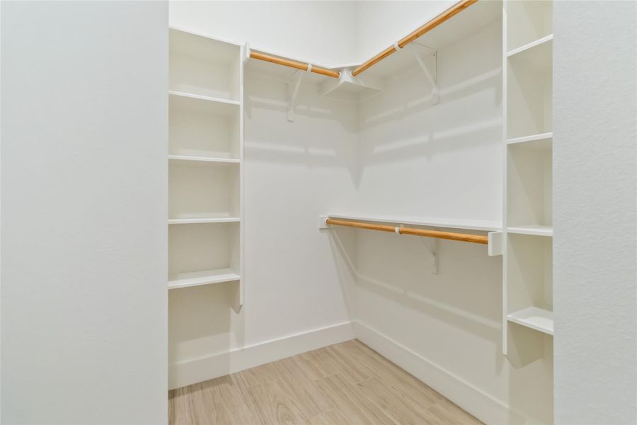 Walk-in closet with built-in shelving in primary ensuite Walk-in closet with built-in shelving in primary ensuite