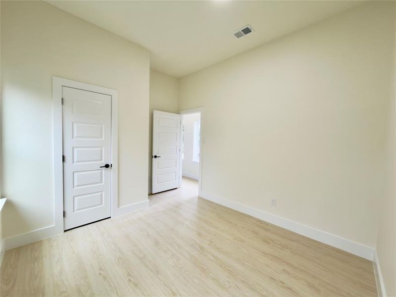 Unfurnished bedroom with light wood-type flooring and baseboards