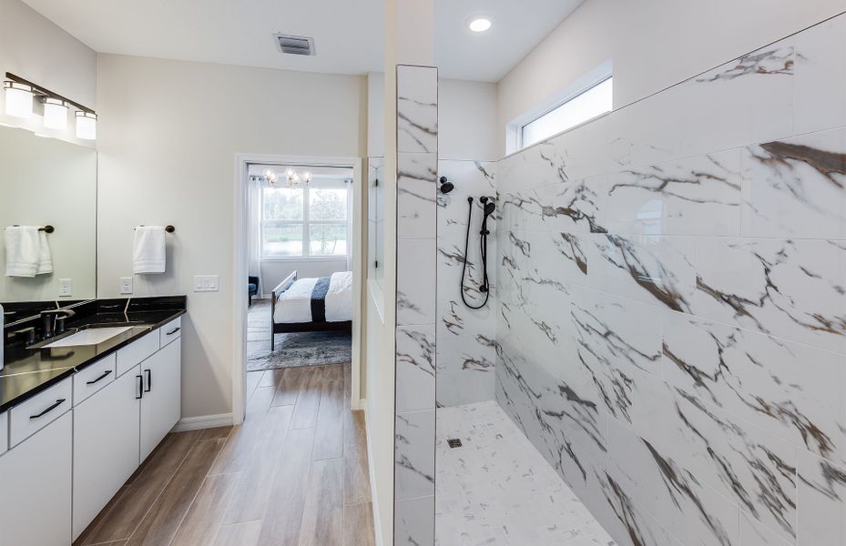 Representative furnished interior of a home built from the Livingston Grande by DiVosta in Bridgewater, Jupiter (Image 31).