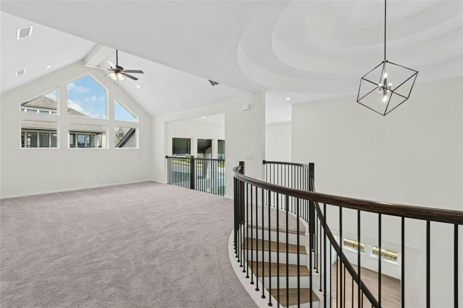Hall with high vaulted ceiling, carpet floors, an upstairs landing, beam ceiling, and a chandelier Hall with high vaulted ceiling, carpet floors, an upstairs landing, beam ceiling, and a chandelier