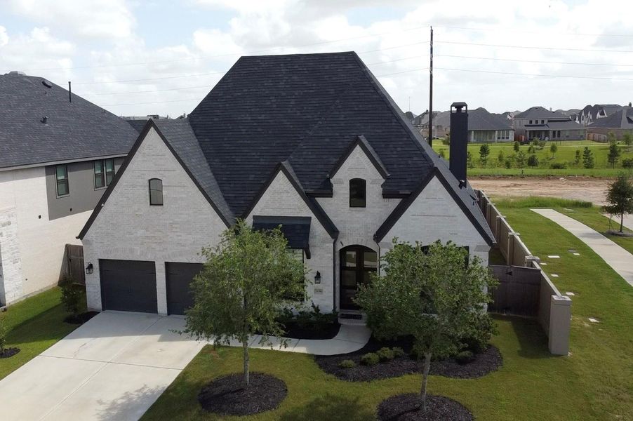 Front exterior of a new home in Cross Creek West, Fulshear, TX, highlighting curb appeal (Image 2).