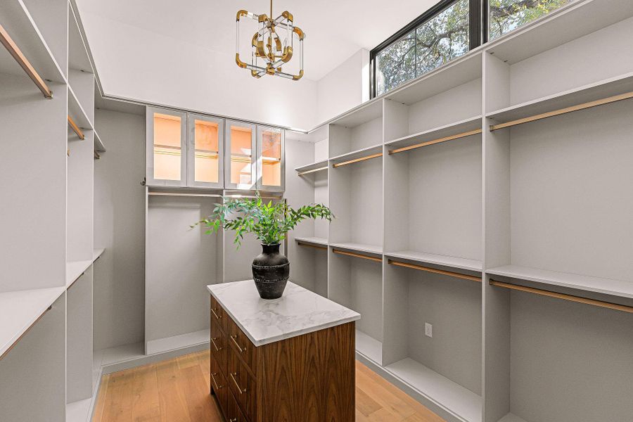 Natural light floods this primary bedroom featuring vaulted ceilings and direct pool access.