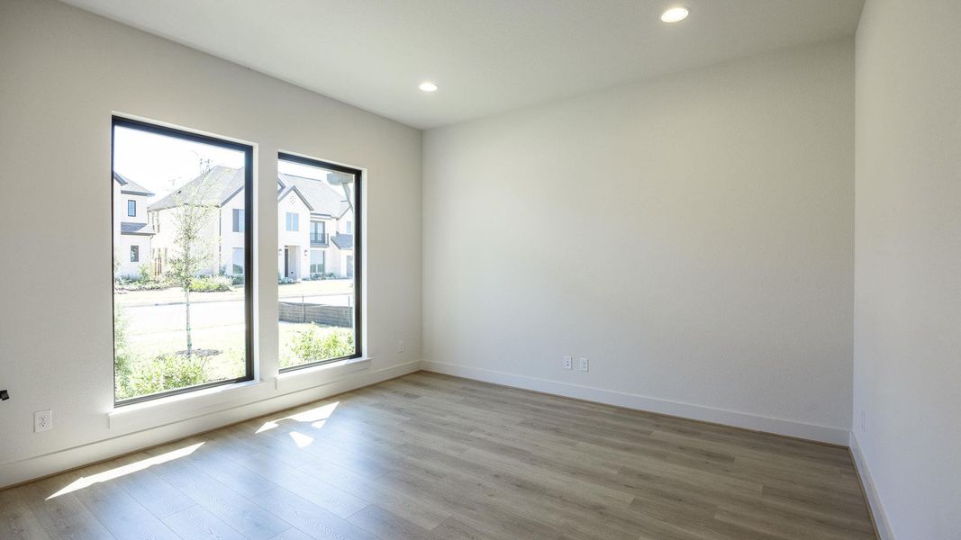 Empty room with light wood-style floors and recessed lighting Empty room with light wood-style floors and recessed lighting