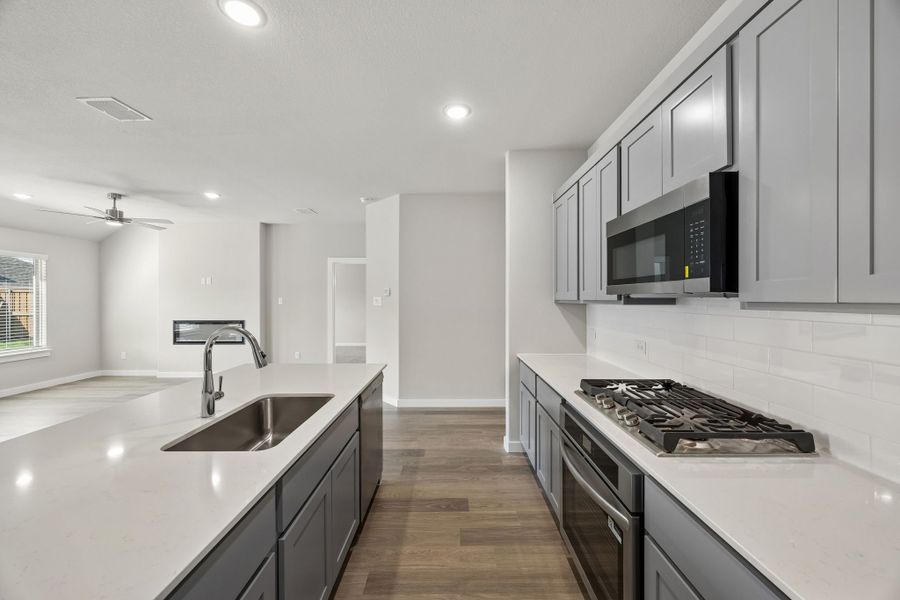 Kitchen in the Emmy II home plan by Trophy Signature Homes - REPRESENTATIVE PHOTO