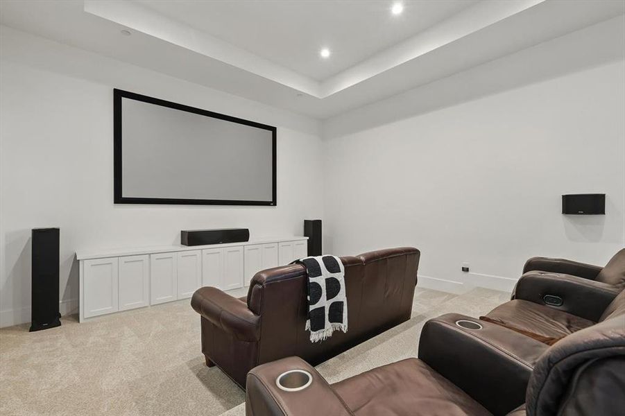 Home theater room featuring light colored carpet, recessed lighting, and a tray ceiling Home theater room featuring light colored carpet, recessed lighting, and a tray ceiling