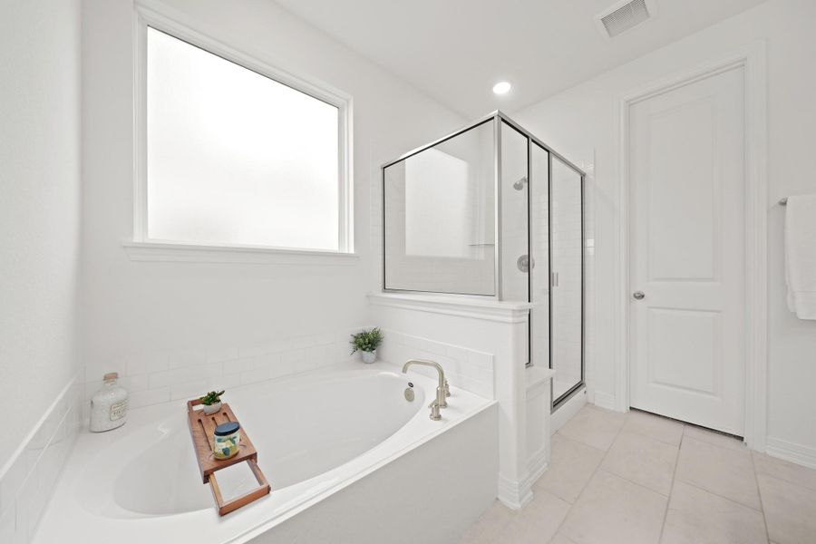 Enjoy a separate soaking tub, walk-in shower, and soft, natural light.