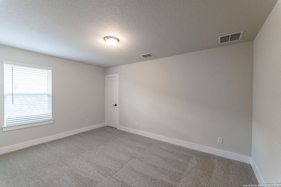 Spacious, unfurnished interior of a new home in The Woodlands at Medina Hills, Mico (Image 20).