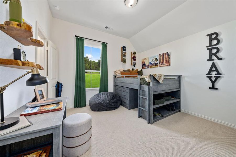 Bedroom featuring carpet flooring and vaulted ceiling