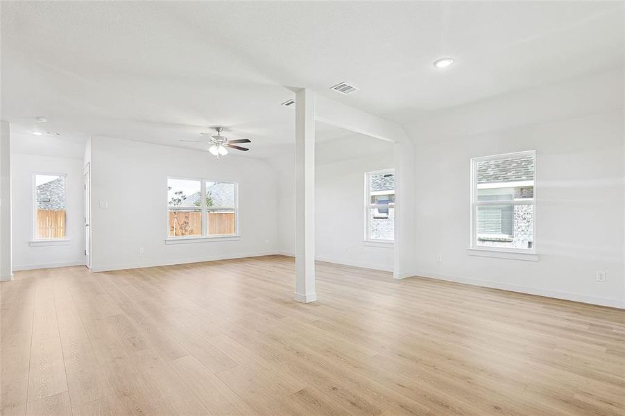 Unfurnished living room with ceiling fan and light hardwood / wood-style floors