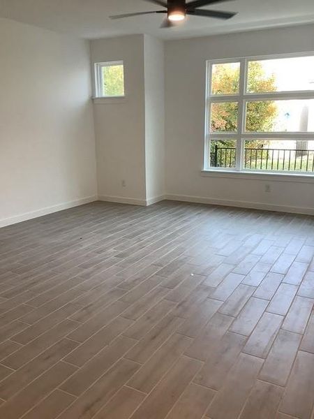 Unfurnished room featuring ceiling fan and wood-type flooring