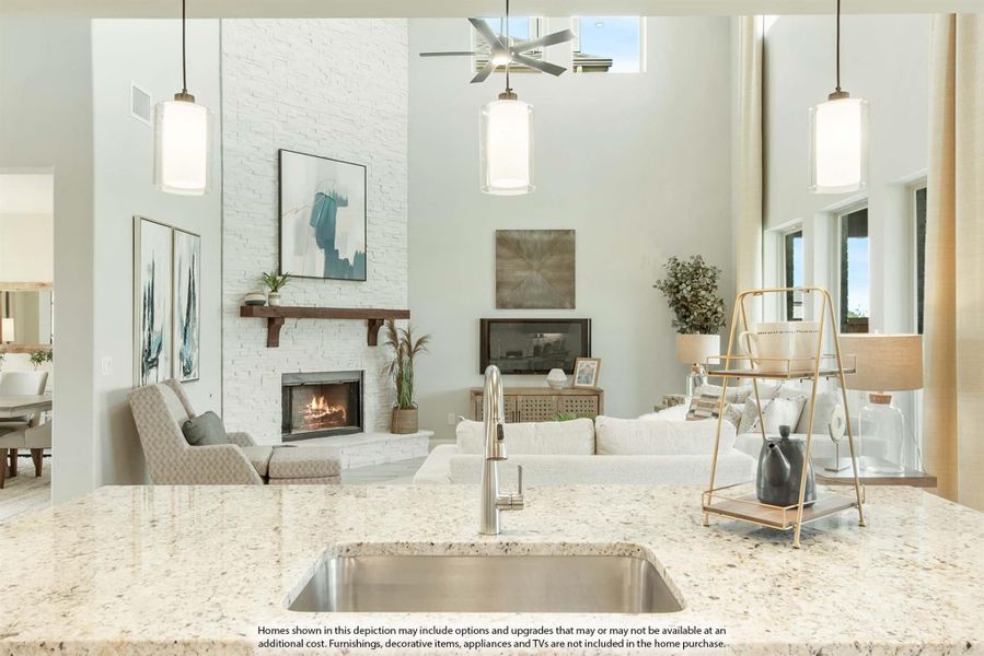 Open-concept living area with granite kitchen island, white brick fireplace, high ceilings, and pendant lights Open-concept living area with granite kitchen island, white brick fireplace, high ceilings, and pendant lights