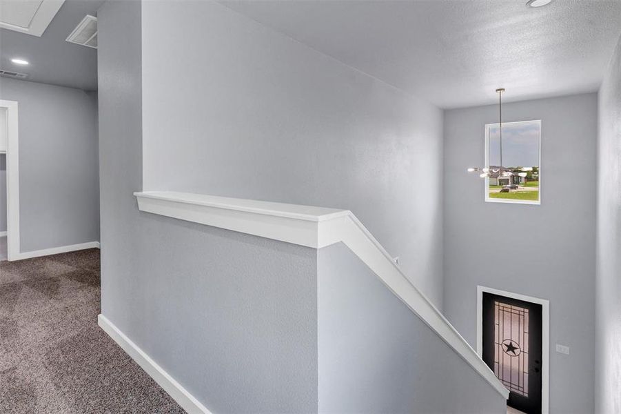 Corridor with carpet, an upstairs landing, and recessed lighting
