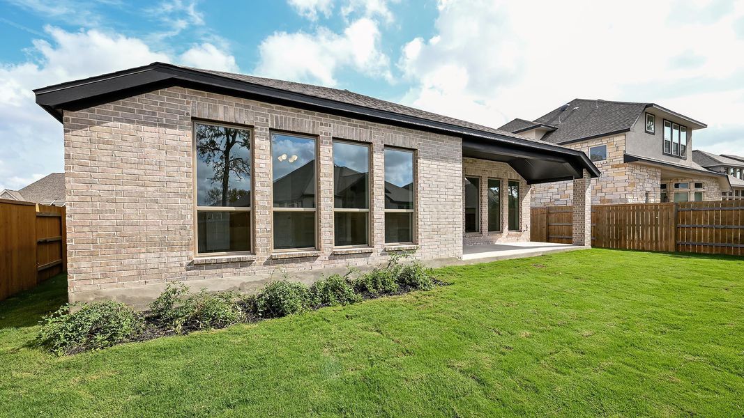 Back of house with a patio area, a fenced backyard, brick siding, and roof with shingles Back of house with a patio area, a fenced backyard, brick siding, and roof with shingles