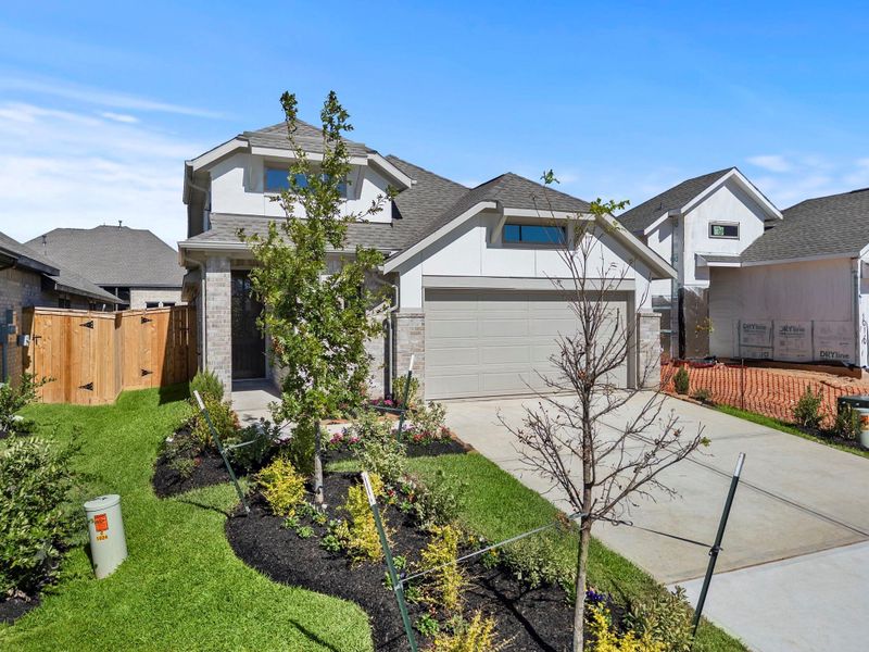 Front exterior of a new home in Grand Central Park, Conroe, TX, highlighting curb appeal (Image 19). Front exterior of a new home in Grand Central Park, Conroe, TX, highlighting curb appeal (Image 19).