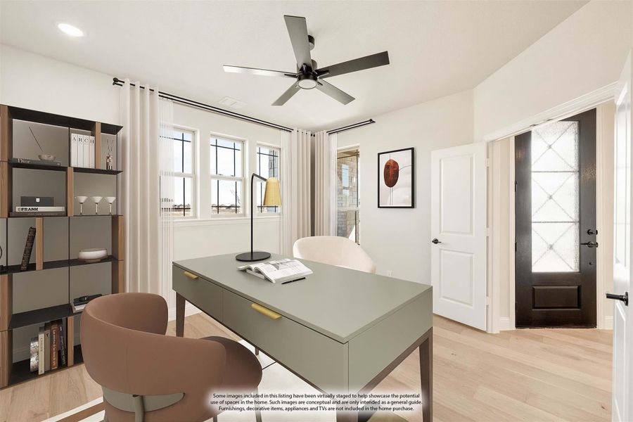Home office with green desk, ceiling fan, open shelving, and light hardwood floors