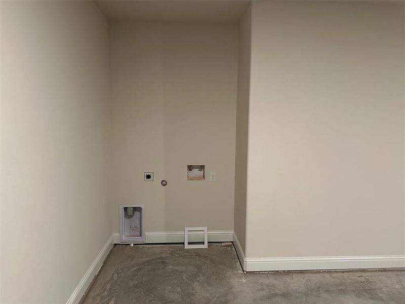 Laundry area with hookup for a washing machine, and electric dryer.