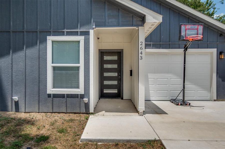 Modern exterior featuring vertical siding in a deep gray hue Modern exterior featuring vertical siding in a deep gray hue