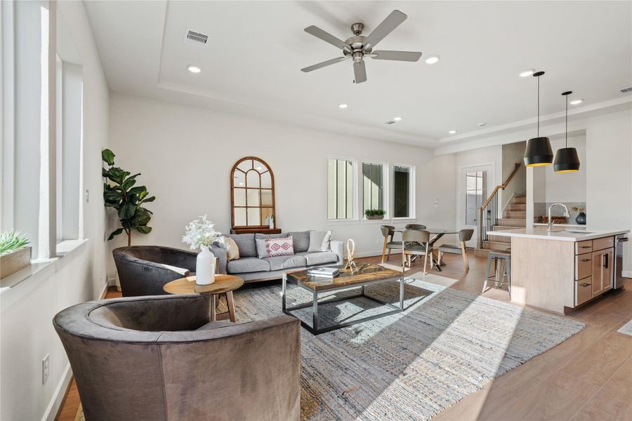 Natural light pulls across the living area from the front windows all the way through to the kitchen, keeping the whole level feeling open. Natural light pulls across the living area from the front windows all the way through to the kitchen, keeping the whole level feeling open.