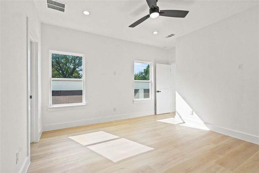 Empty room featuring light wood-style flooring, recessed lighting, and a ceiling fan