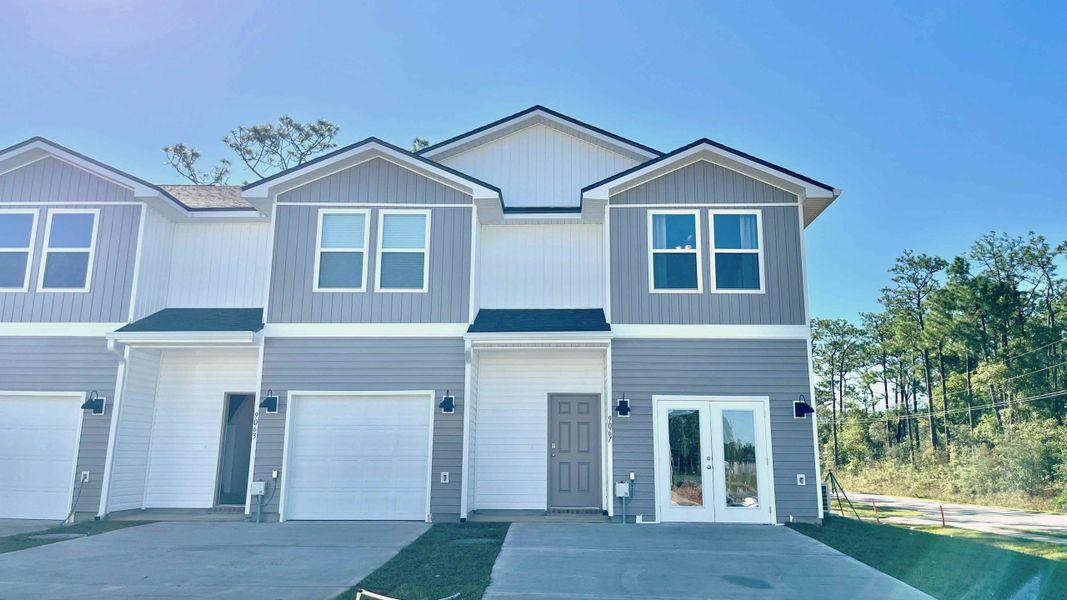 Front exterior of a new home in Genoa Landing Townhomes, Freeport, FL, highlighting curb appeal (Image 2).