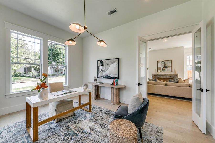 Home office with light hardwood / wood-style flooring