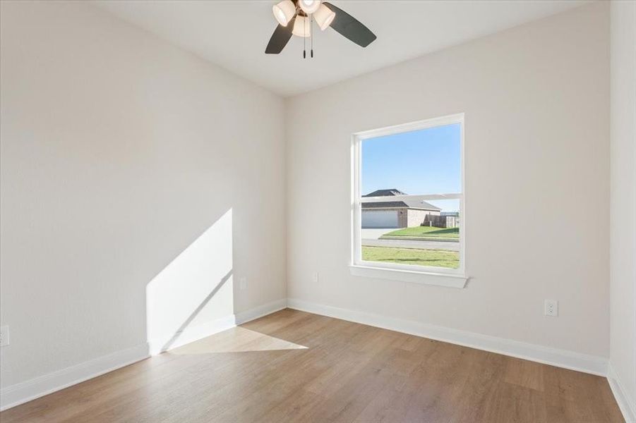 Spare room featuring light wood-type flooring and ceiling fan