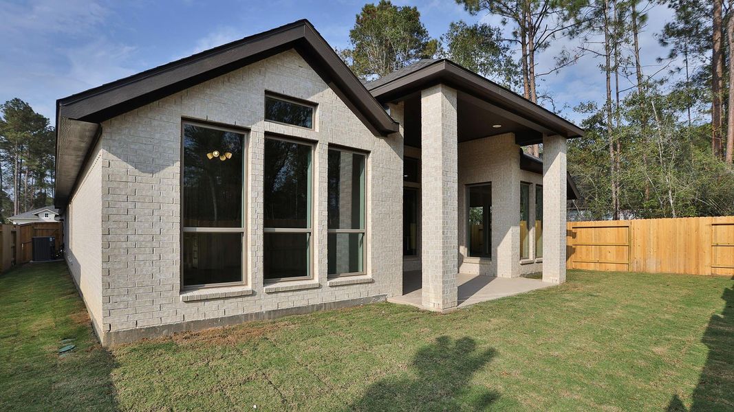 Exterior details and patio area of a home in Woodhavyn 50', Magnolia (Image 3). Exterior details and patio area of a home in Woodhavyn 50', Magnolia (Image 3).