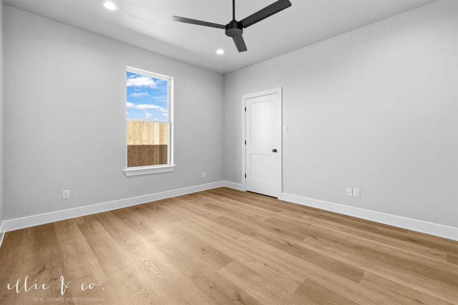 Empty room featuring light wood-type flooring, recessed lighting, and a ceiling fan