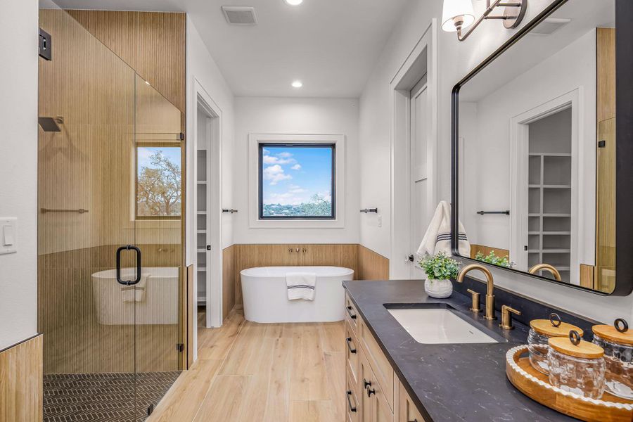 Bathroom with a stall shower, a spacious closet, visible vents, and vanity