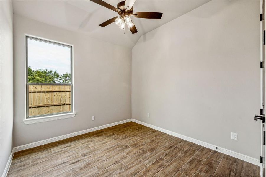 Empty room with light wood-type flooring and ceiling fan