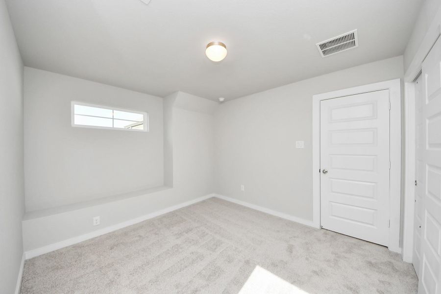 Generously sized secondary bedrooms featuring spacious closets, soft and inviting carpeting underfoot, large windows allowing plenty of natural light, and the added touch of privacy blinds for your personal retreat. Sample photo of completed home with similar floor plan. Actual colors and selections may vary.