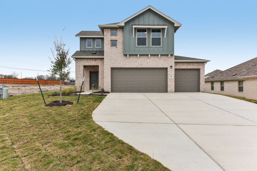 Front exterior of a new home in Crosswinds, Kyle, TX, highlighting curb appeal (Image 1). Front exterior of a new home in Crosswinds, Kyle, TX, highlighting curb appeal (Image 1).